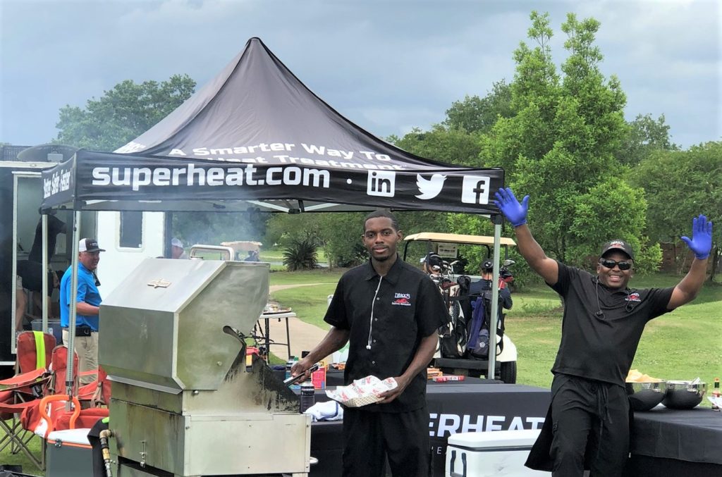 Men cooking at a Superheat company golf tournament